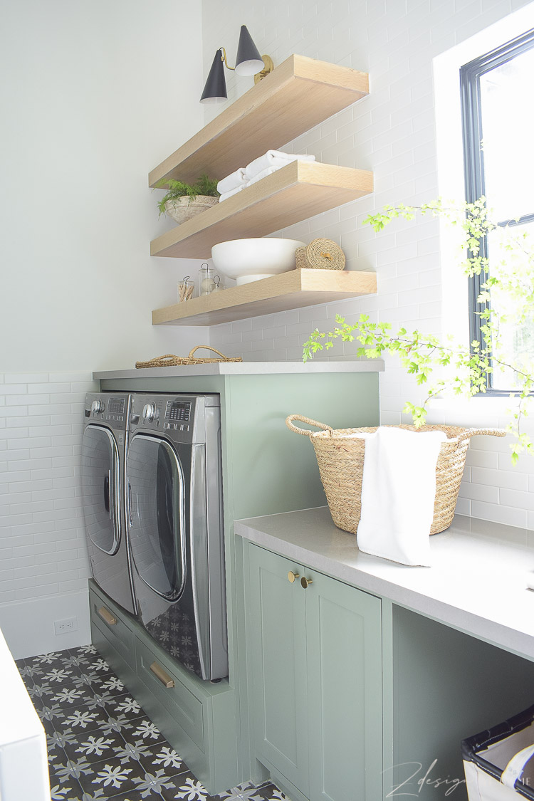 builtin washer and dryer with white oak shelves above 