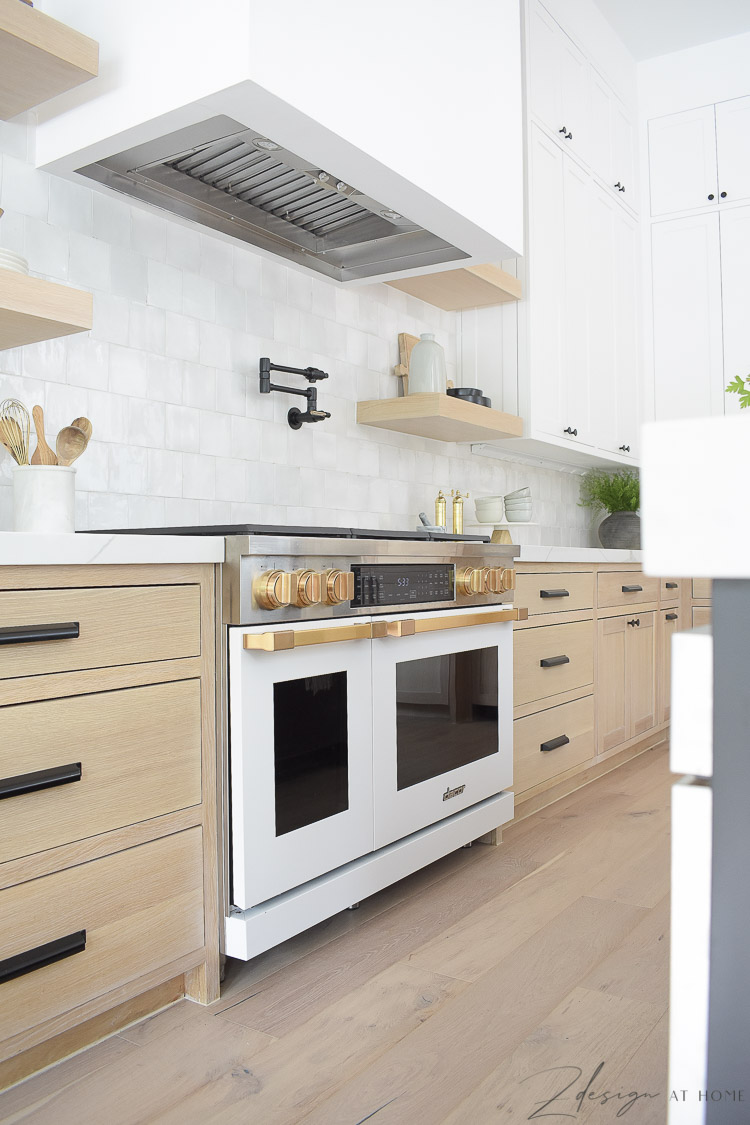 modern farmhouse kitchen with black white and white oak cabinets - white Dacor Range 