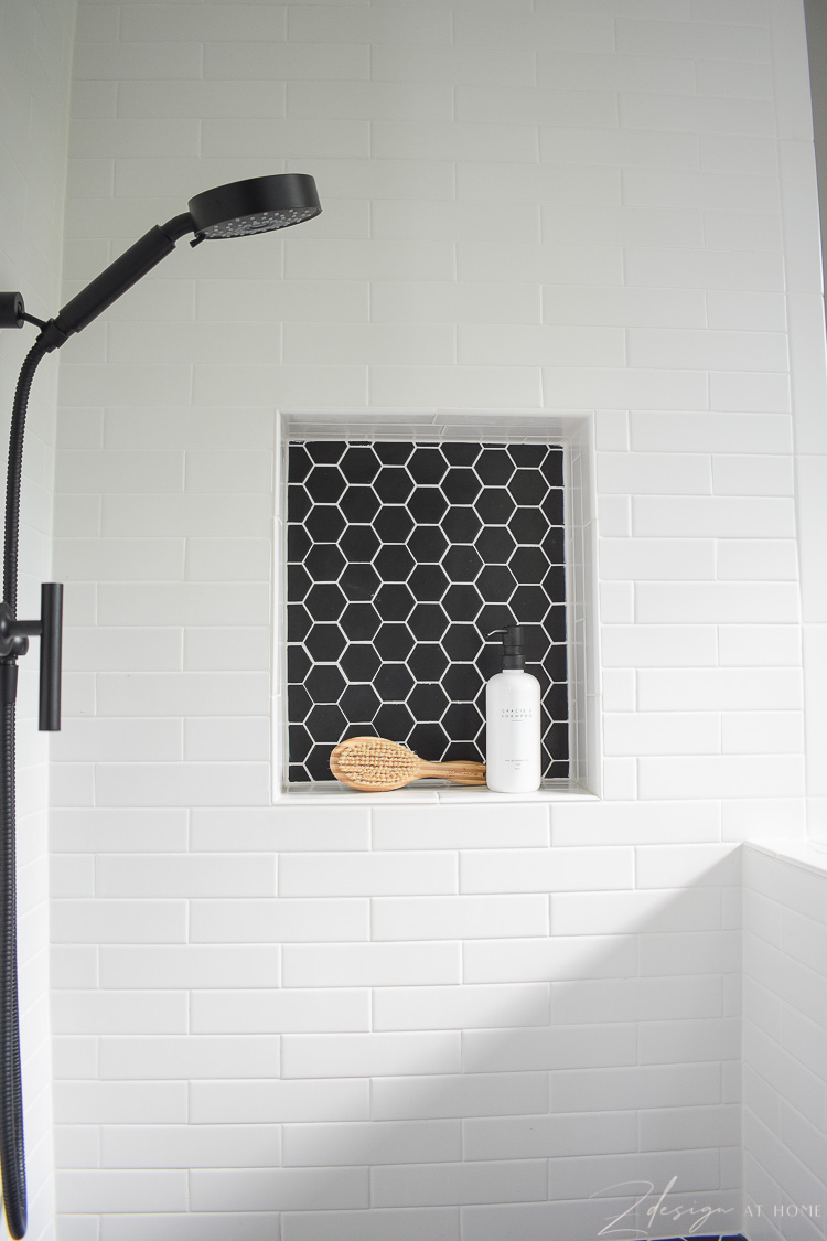 niche for dog wash with white tile and black hex tile with white grout 