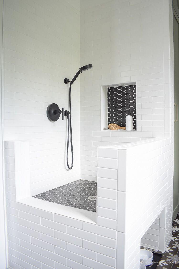 dog wash with white tile and black hex tile with shower niche 