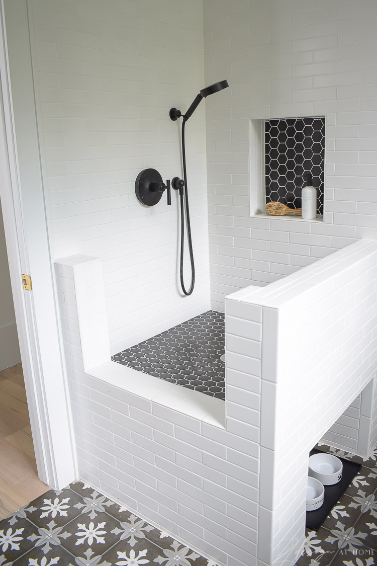 black and white tile dog wash with black hex tile, white grout 