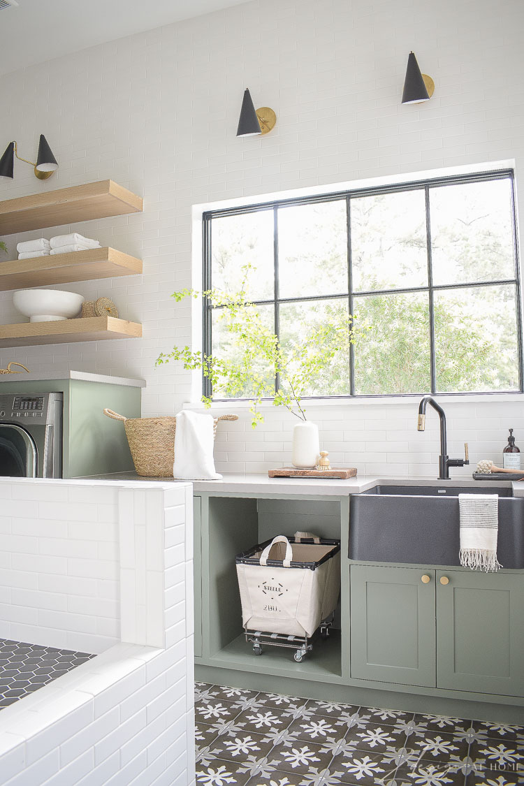 elegant laundry room with gray green cabinets