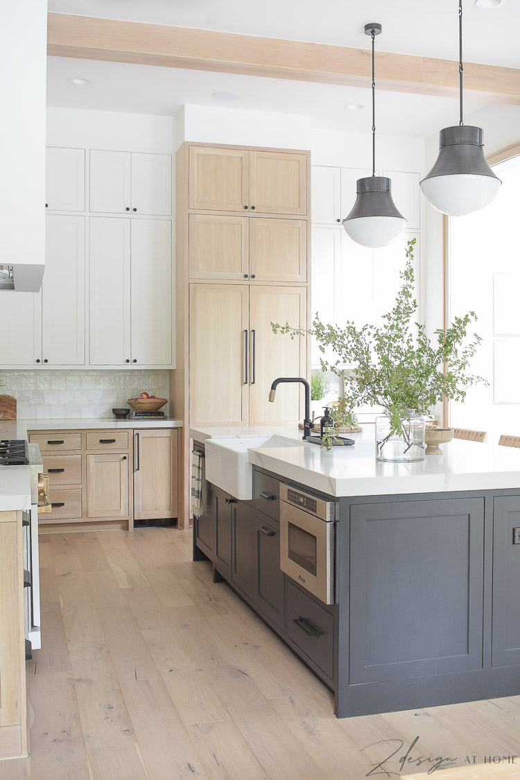 modern farmhouse kitchen with black island white oak cabinets 