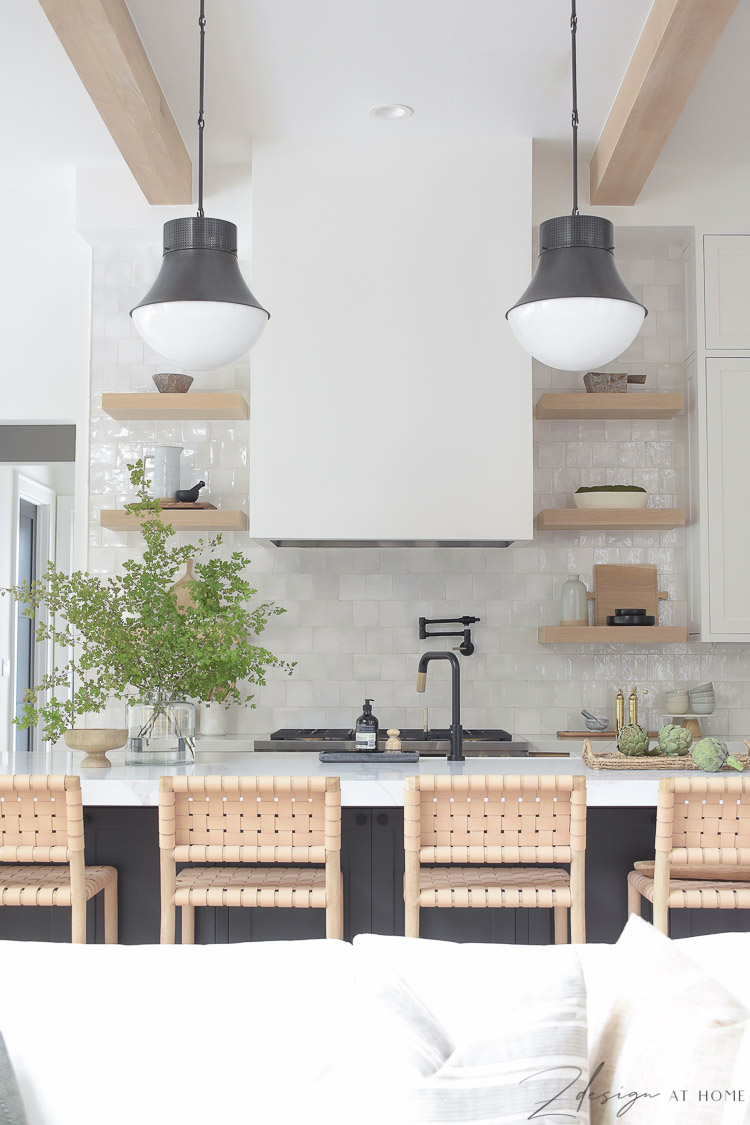 modern farmhouse kitchen with white sheetrock hood and black pendants 