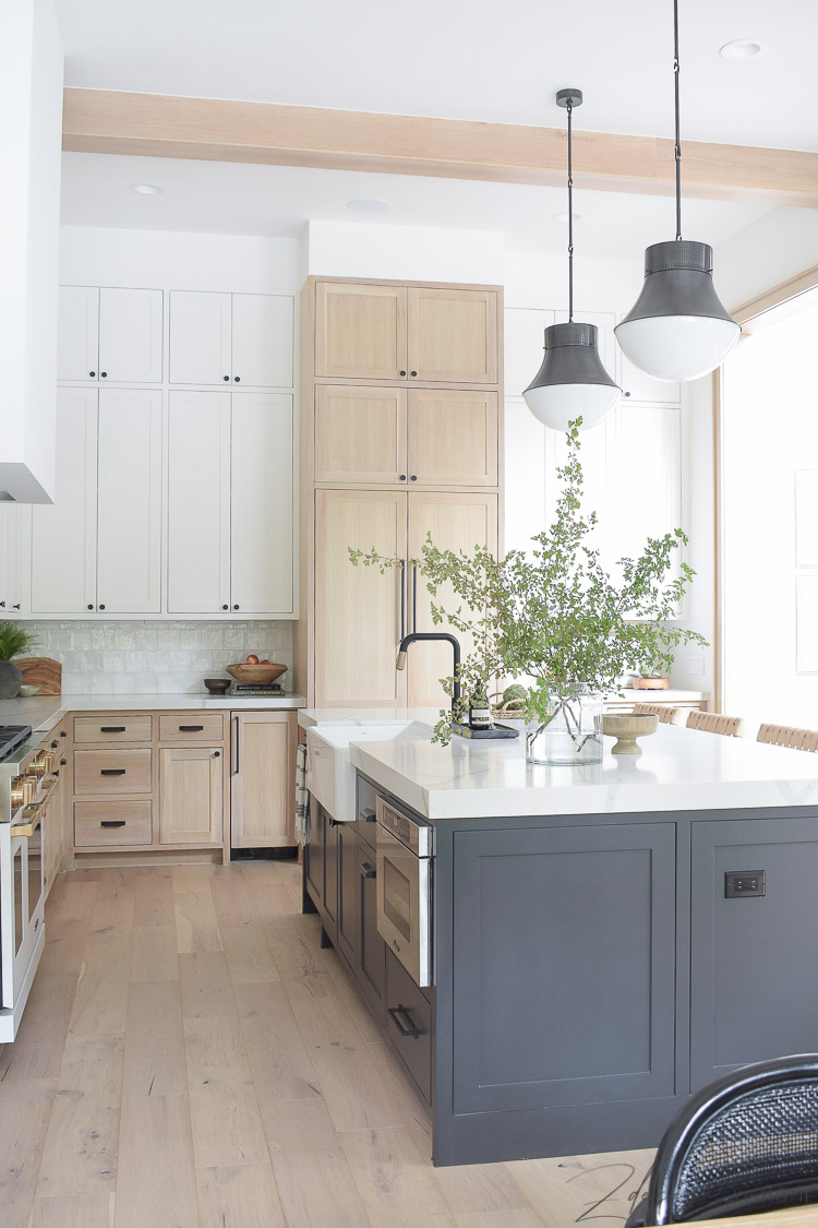 modern farmhouse kitchen with 3 cabinet colors - white oak, sw snowbound and black island