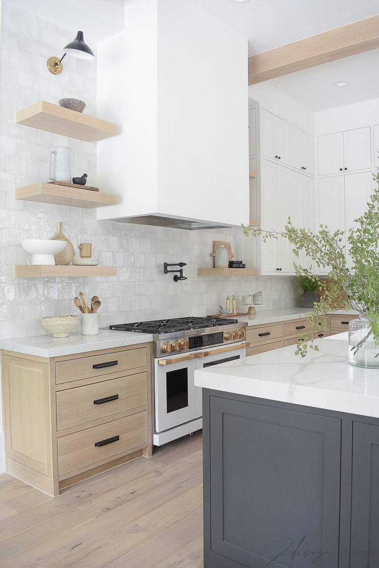 white sheetrock range hood with white oak shelves and cabinets