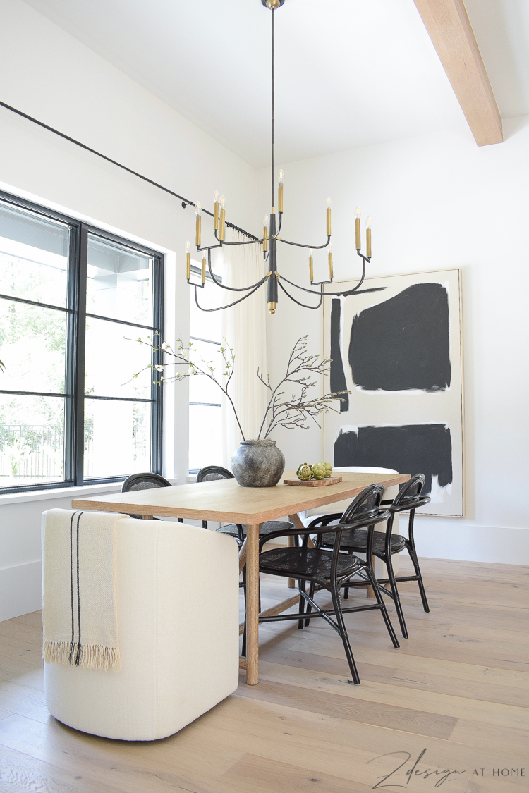 transitional modern farmhouse dining room with black and white theme and oversized art