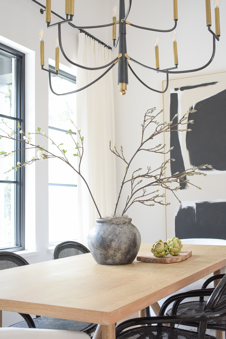 transitional modern farmhouse dining room with black and white theme and oversized art