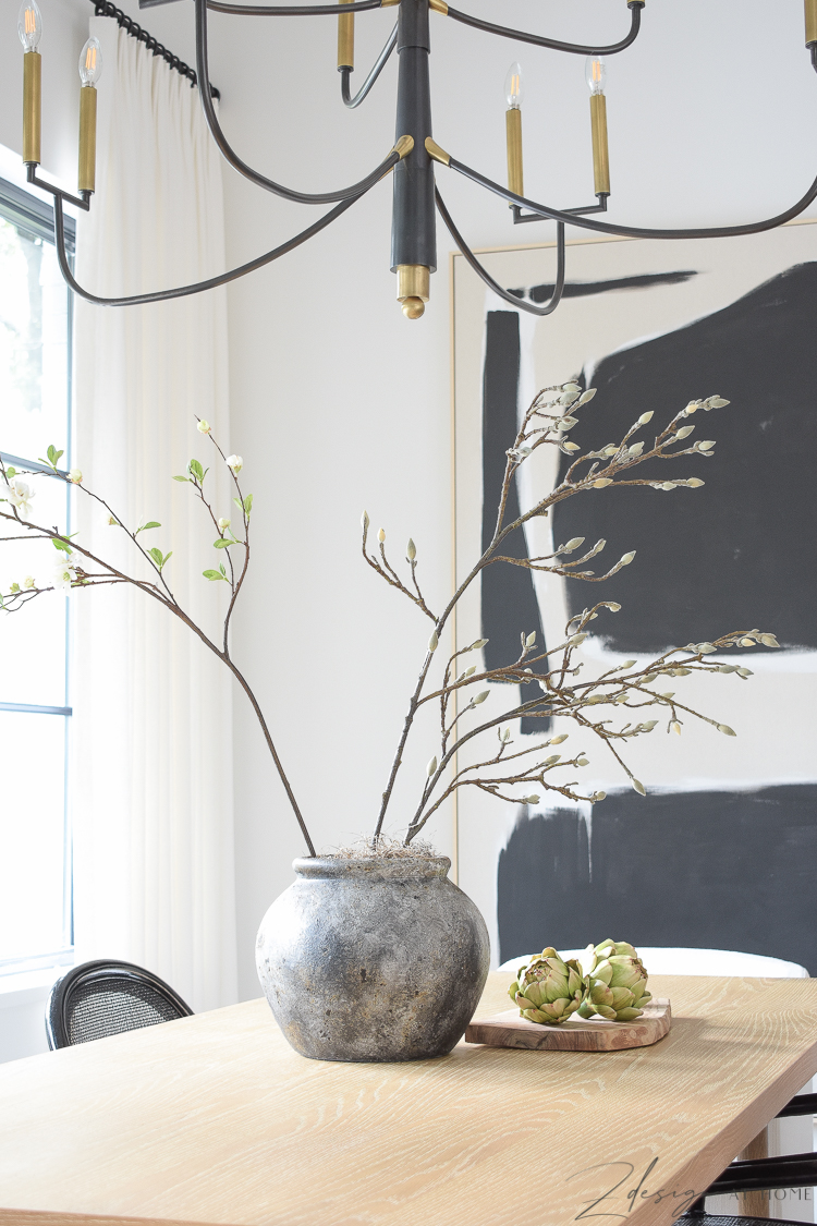 terra-cotta clay jar with faux magnolia and quince stems 