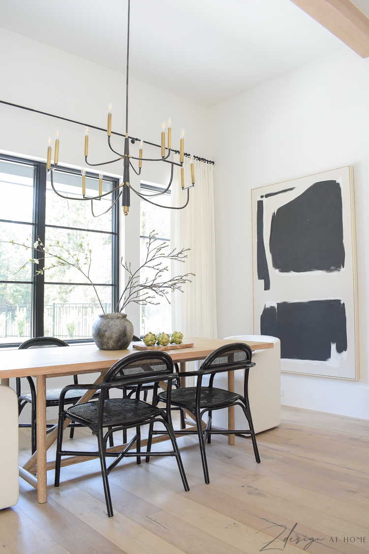 transitional modern farmhouse dining room with black and white theme and oversized chandelier
