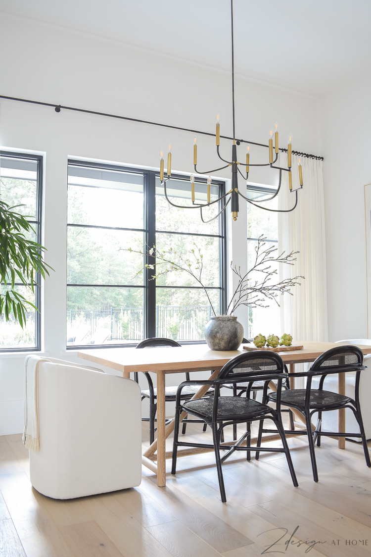 transitional modern farmhouse dining room with black and white theme and oversized chandelier