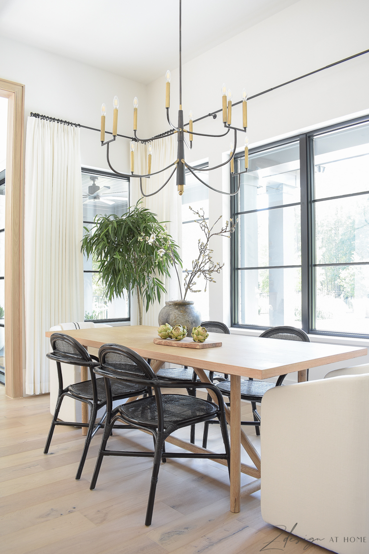 modern farmhouse dining table with black cane rattan side chairs 