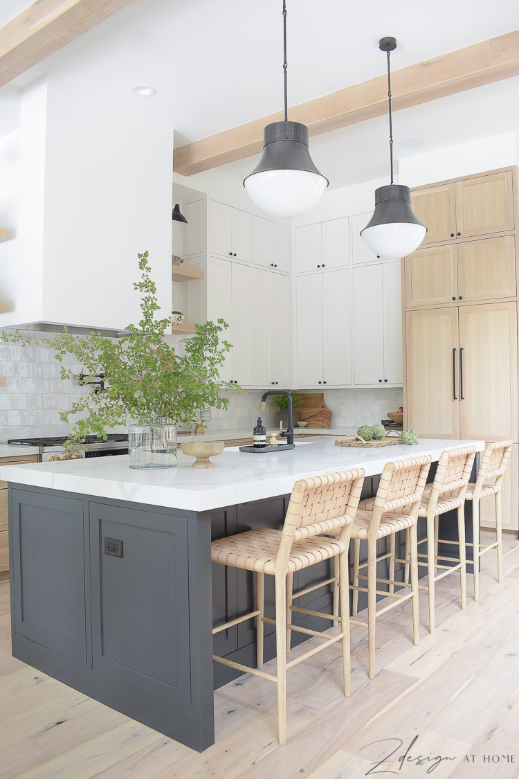 modern farmhouse kitchen with black island, white cabinets, white oak cabinets 