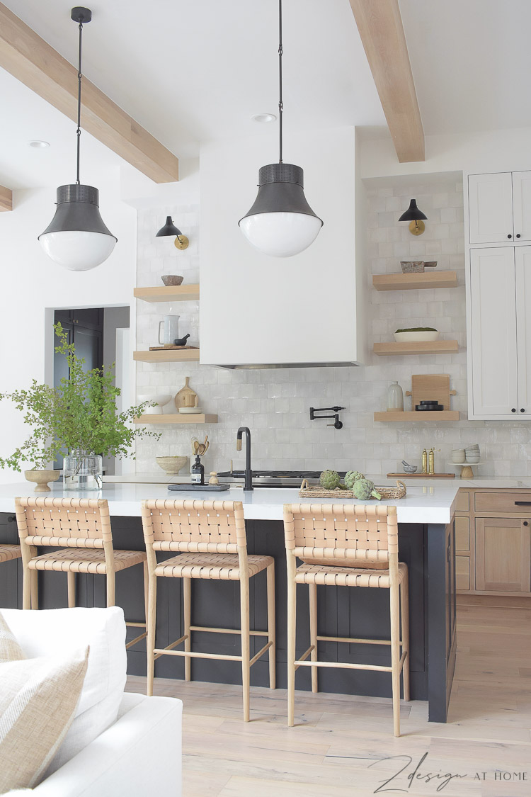 Modern farmhouse kitchen in black, white and white oak with zellige backsplash and quite quartz countertops with veining 