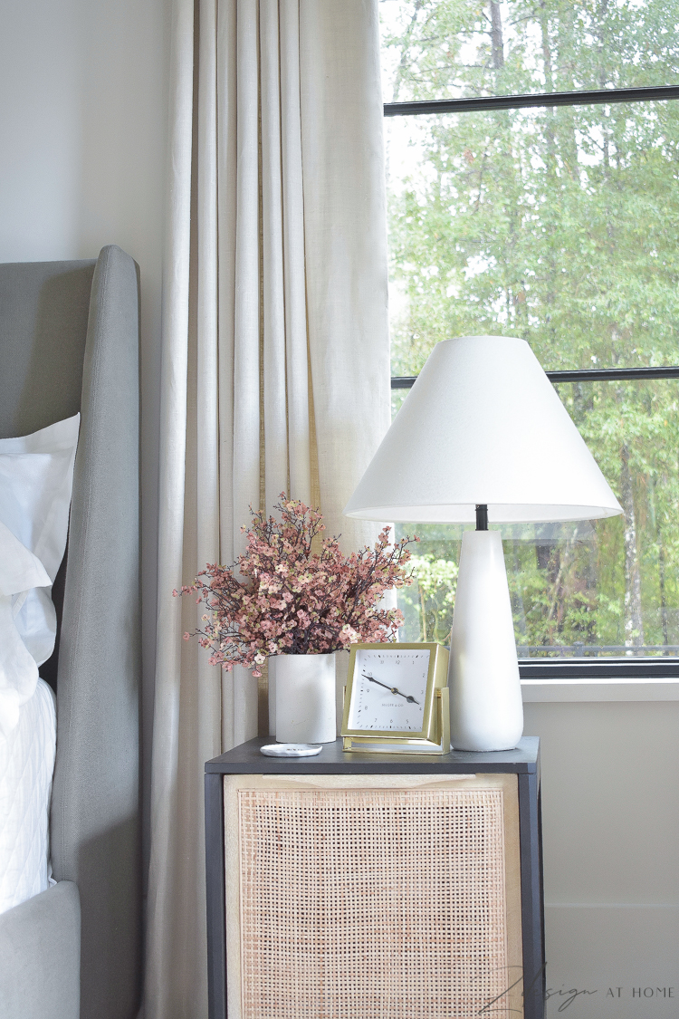 black and natural cane nightstand styled with fall faux stems 