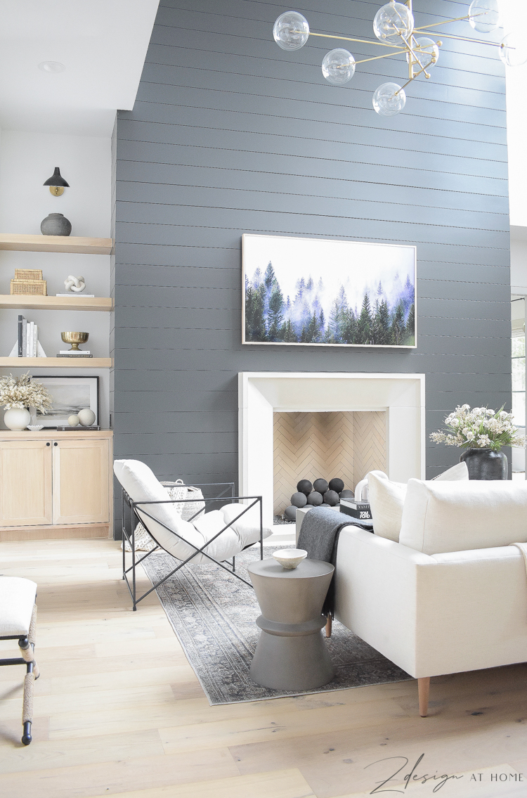 fall living room with black shiplap fireplace 