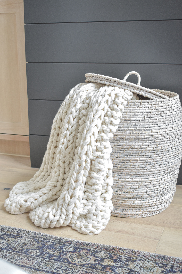 cream chunky knit throw in basket