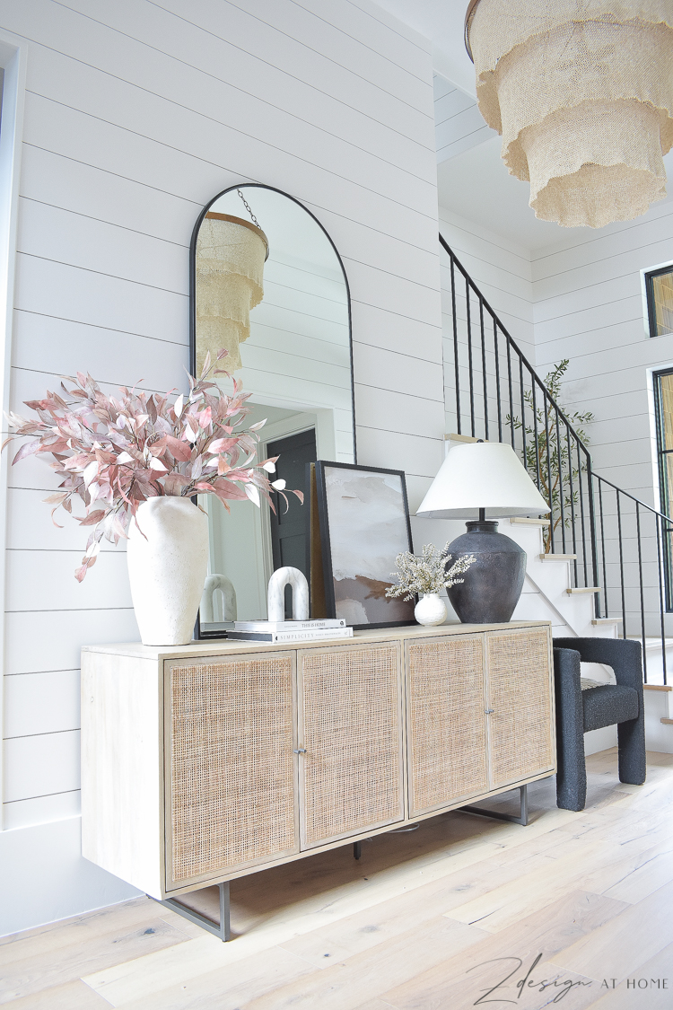 fall entryway with shiplap walls and large arched metal black mirror