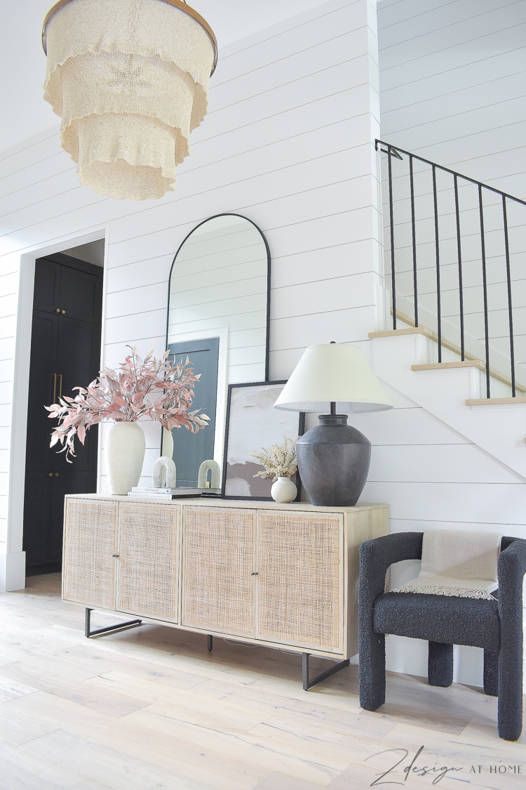 entryway decorated for fall with shiplap walls