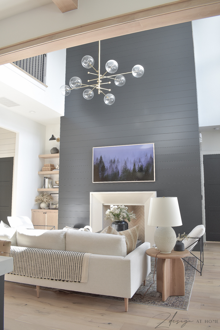 transitional modern living room styled for fall and black shiplap wall/fireplace