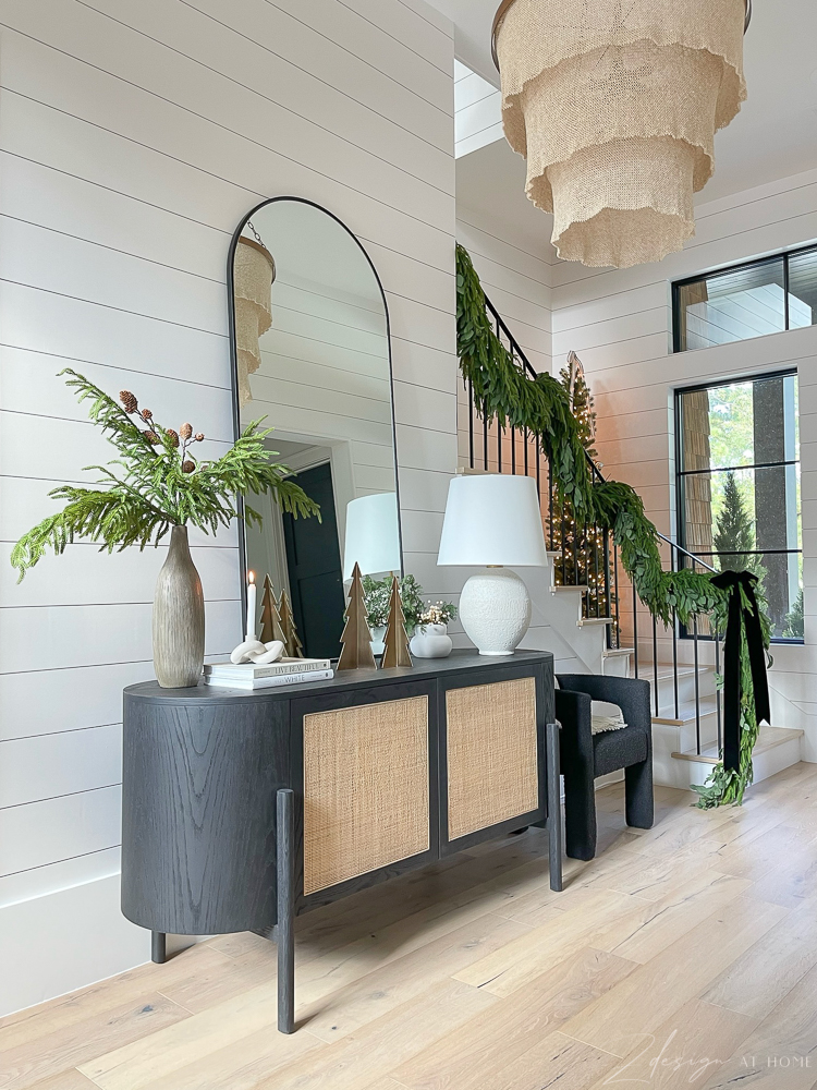 black cane credenza buffet styled in entryway for christmas holidays