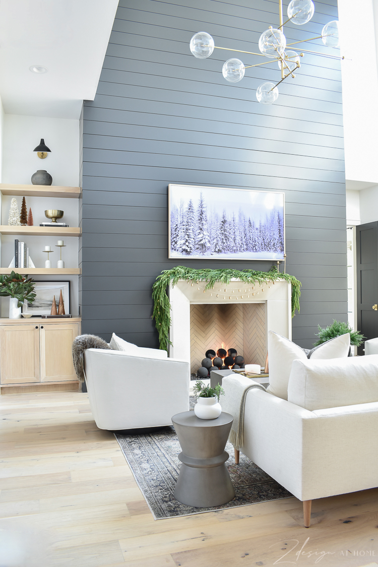 modern christmas living room with black shiplap fireplace wall 