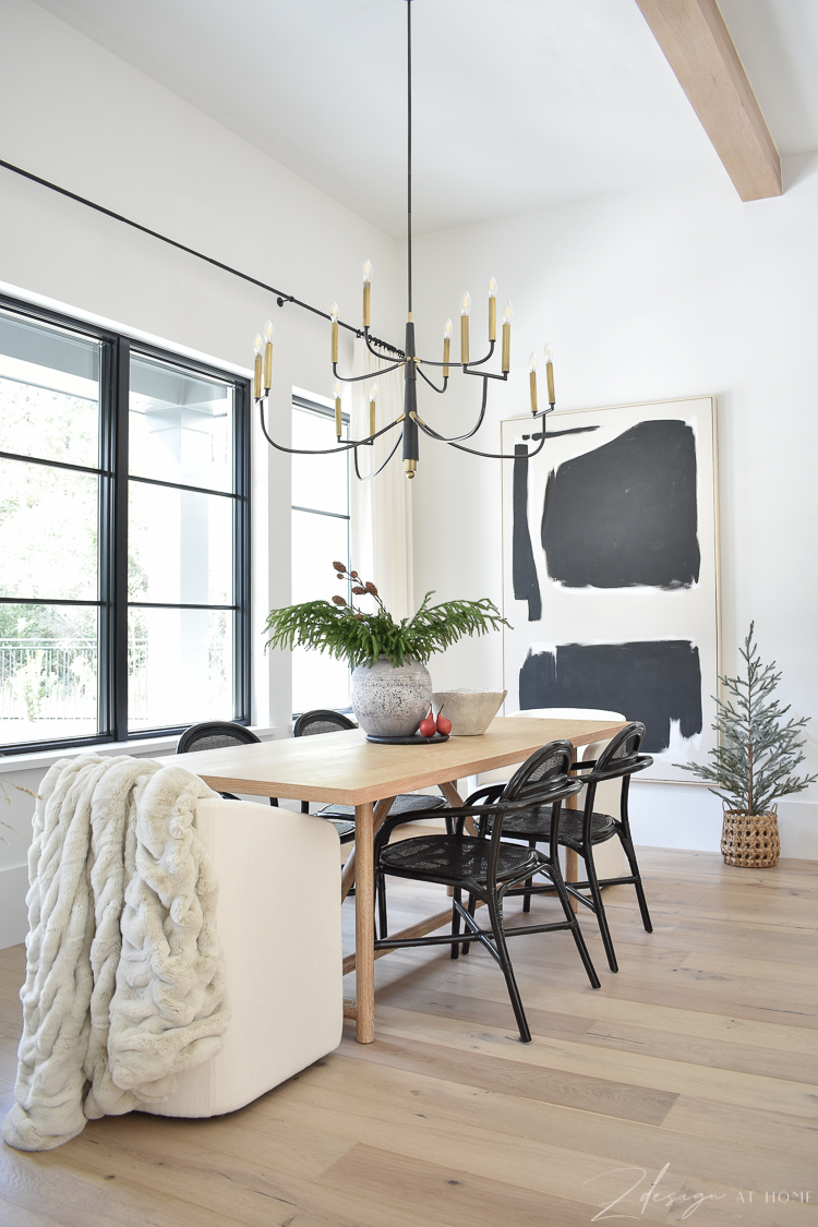 modern farmhouse dining room decorated for christmas - black cane dining chairs and modern christmas decor 