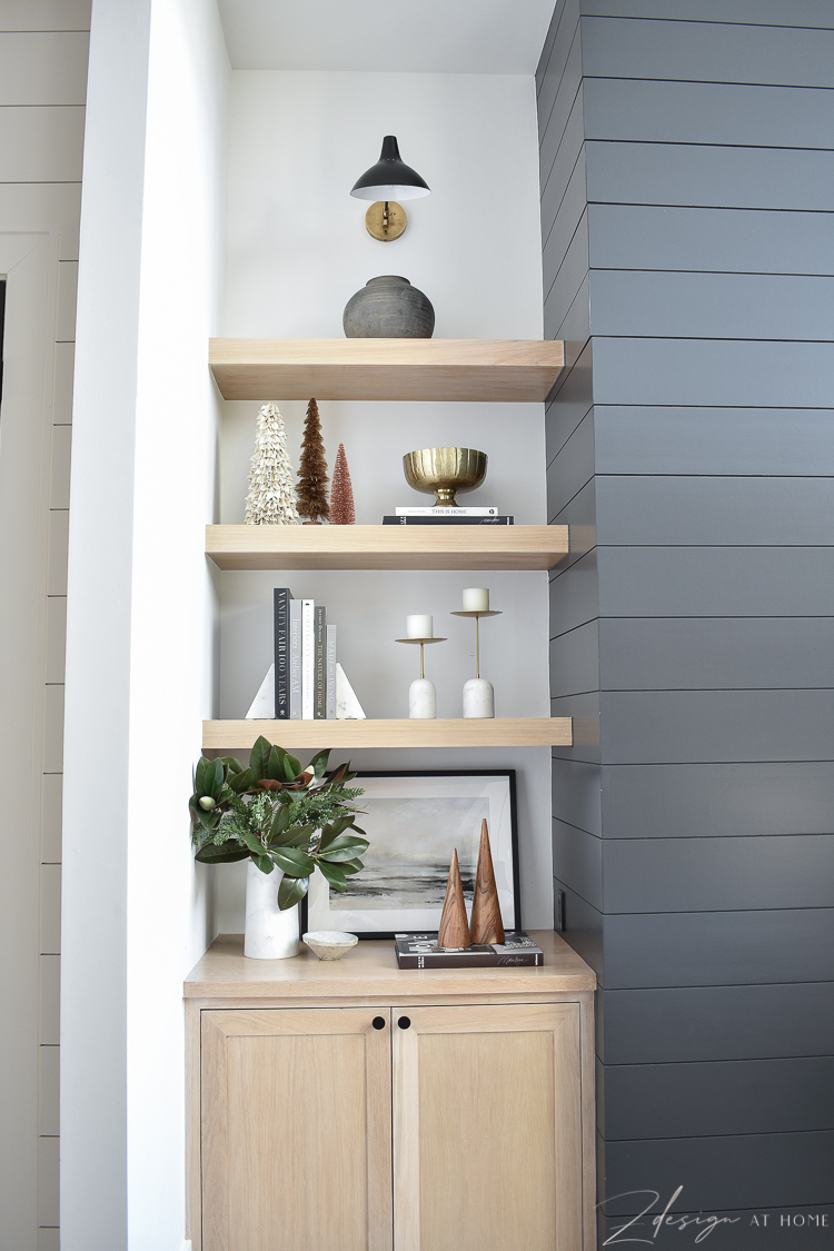 white oak bookshelves styled with modern christmas decor 