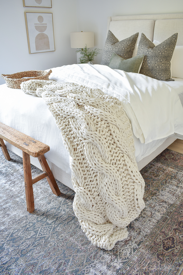 chunky knit throw at end of guest bed