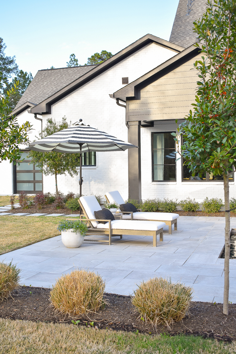 BHG Walmart outdoor umbrella for spring with modern pool pavers and black and white house exterior