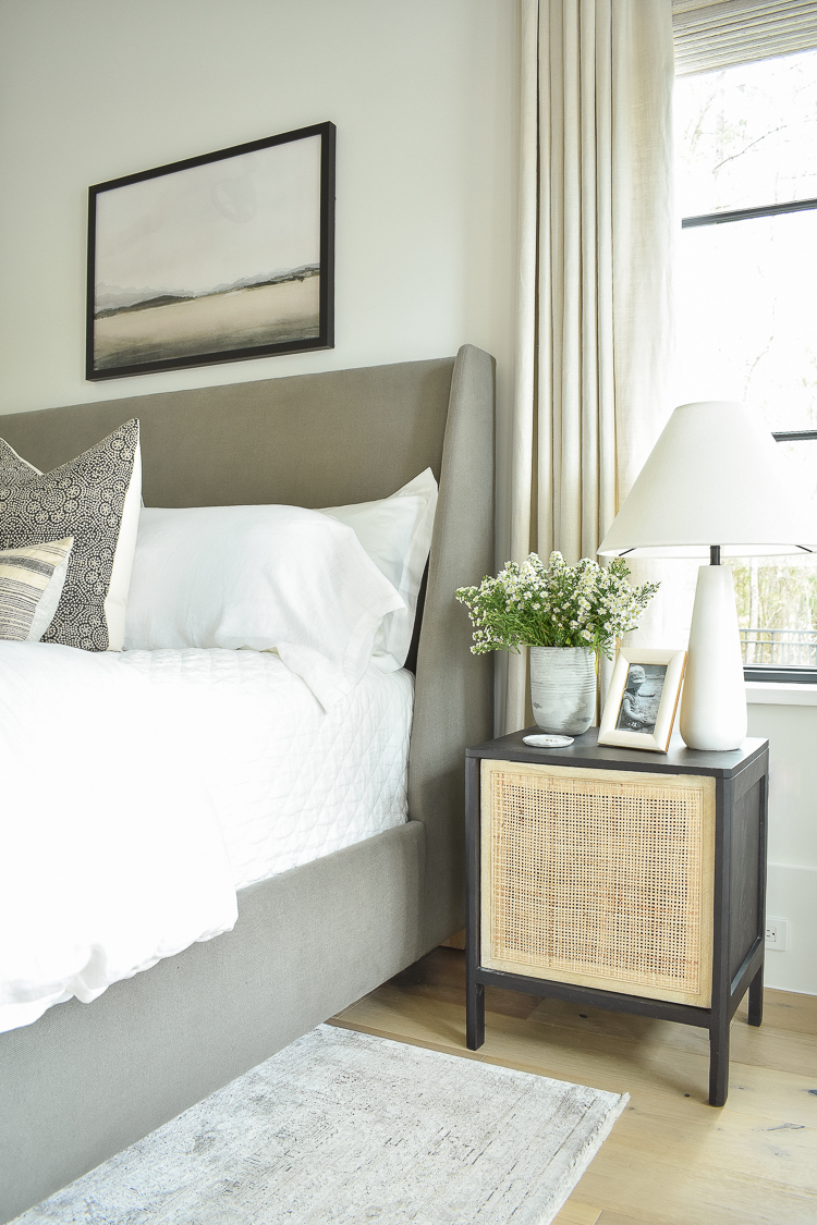 master bedroom with cane and black nightstands 