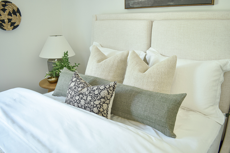 black floral pillow, green lumbar pillow, textured line pillows in guest bedroom 