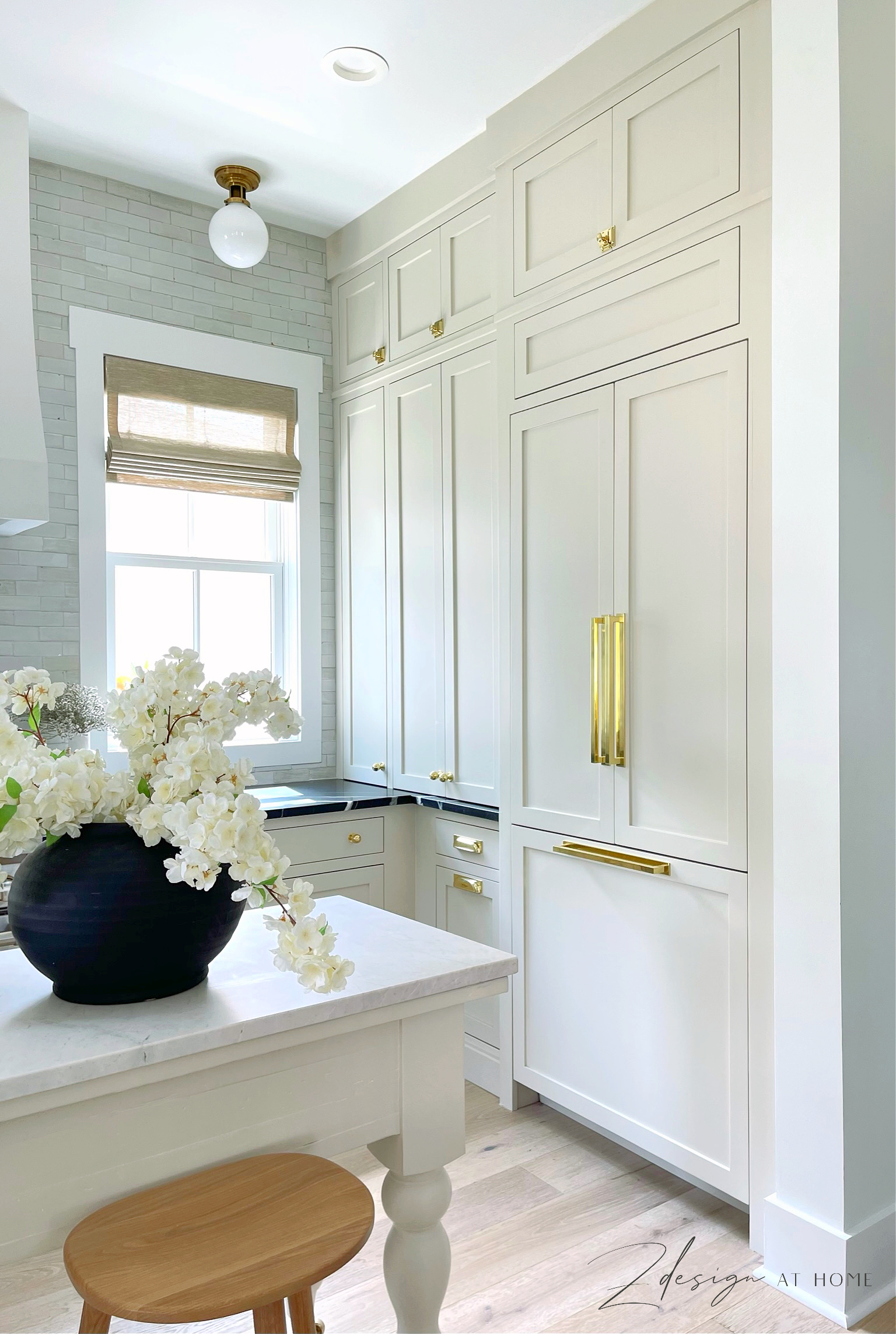 wolf range and french range hood in cottage kitchen with natural cream panel ready cabinets and fridge and zellige tile backsplash to ceiling 