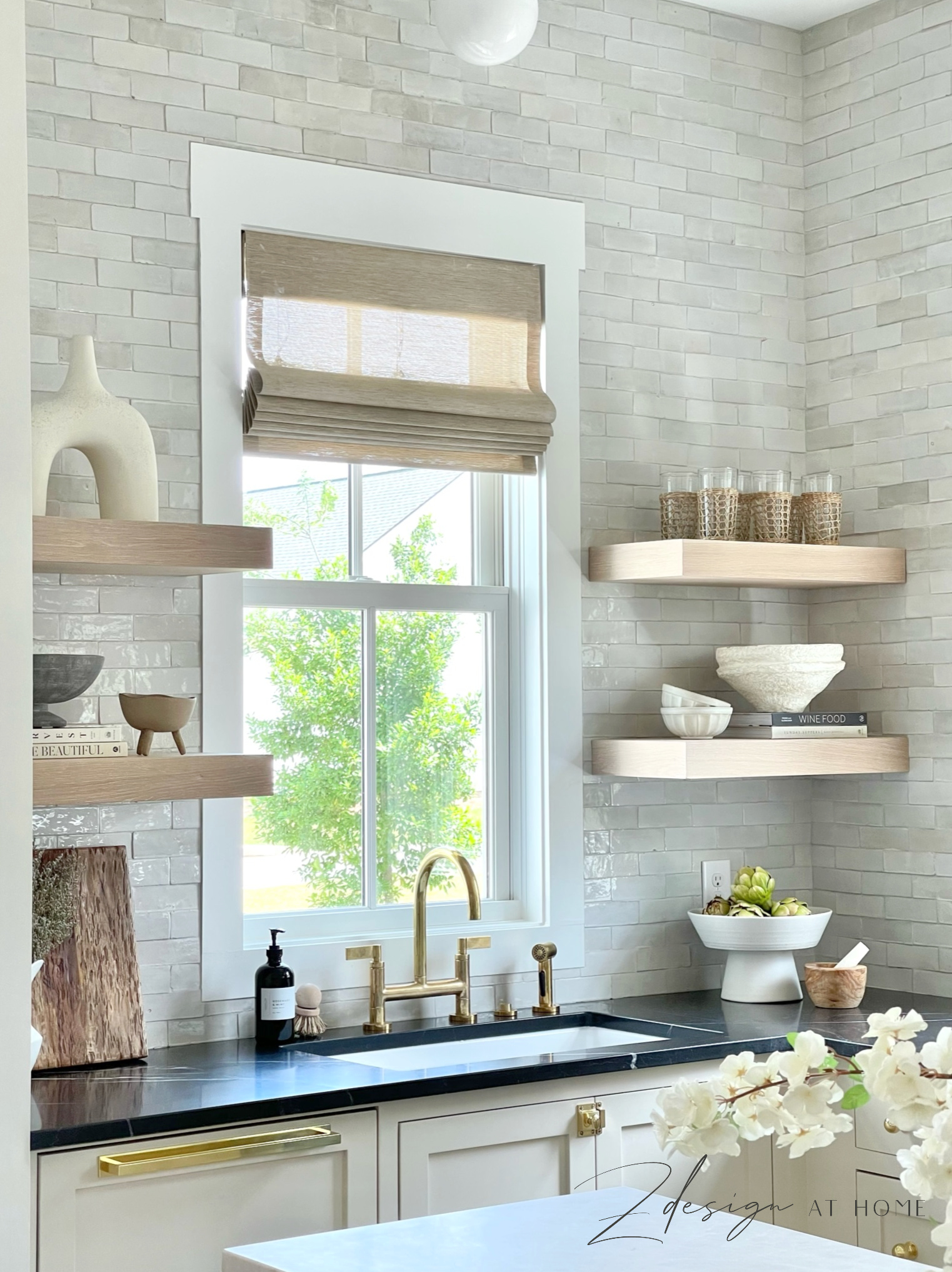 white oak open shelves in english inspired kitchen, black marble countertops and unlacquered brass fixtures 