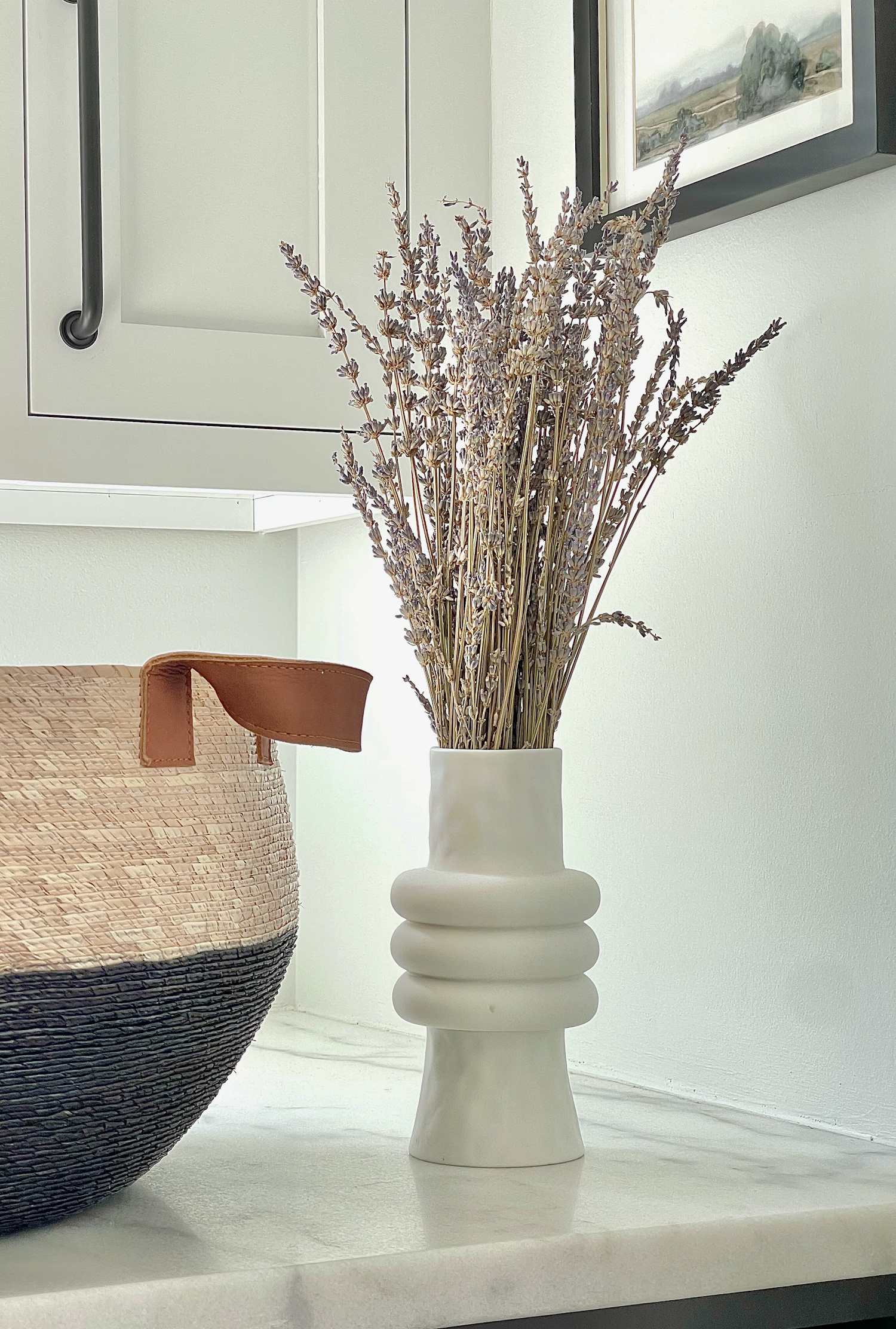lavender bunch styled in white organic shaped vase