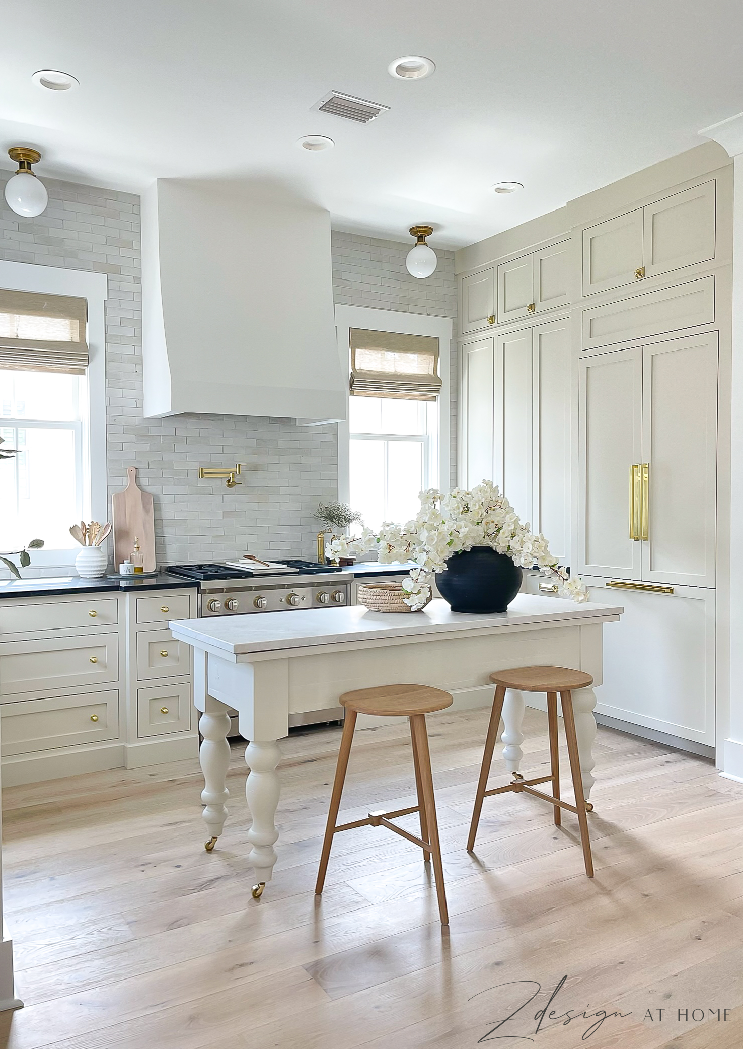 english cottage inspired kitchen with ben moore natural cream cabinets and french range hood 