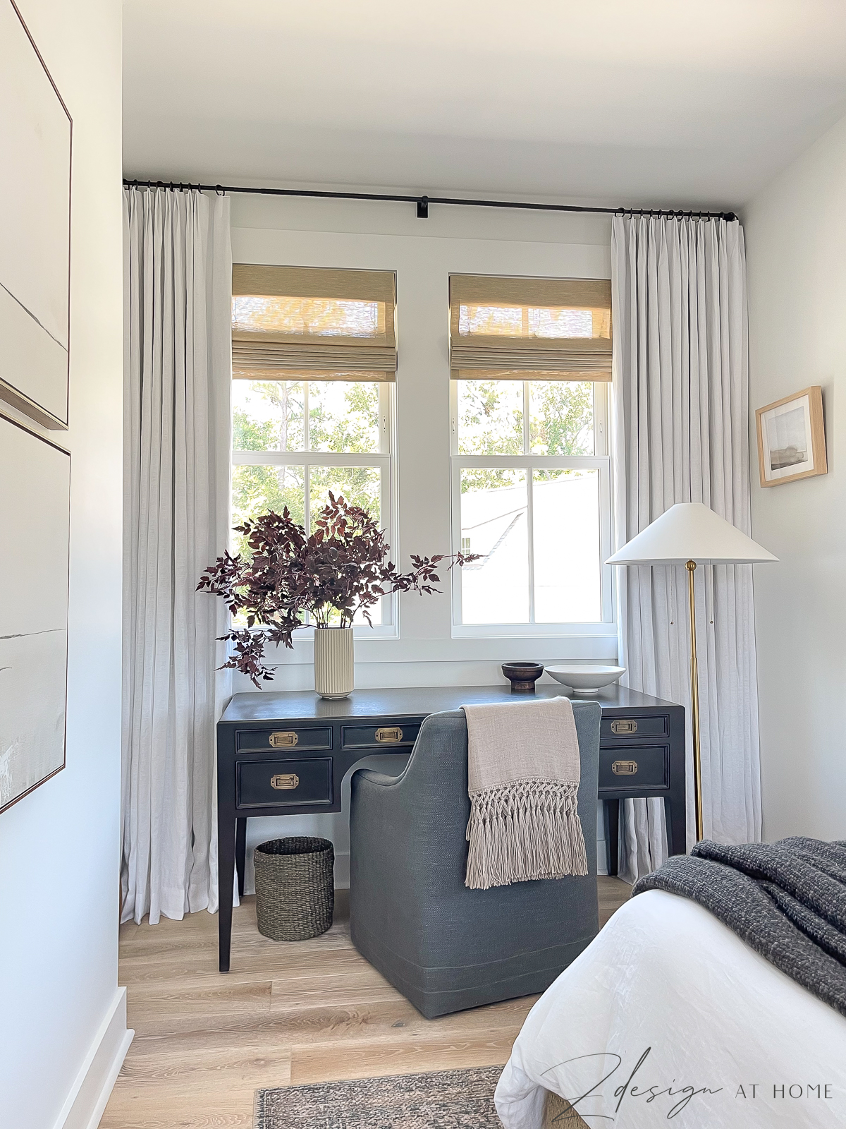 cottage guest room with black desk lined desk chair in front of window 