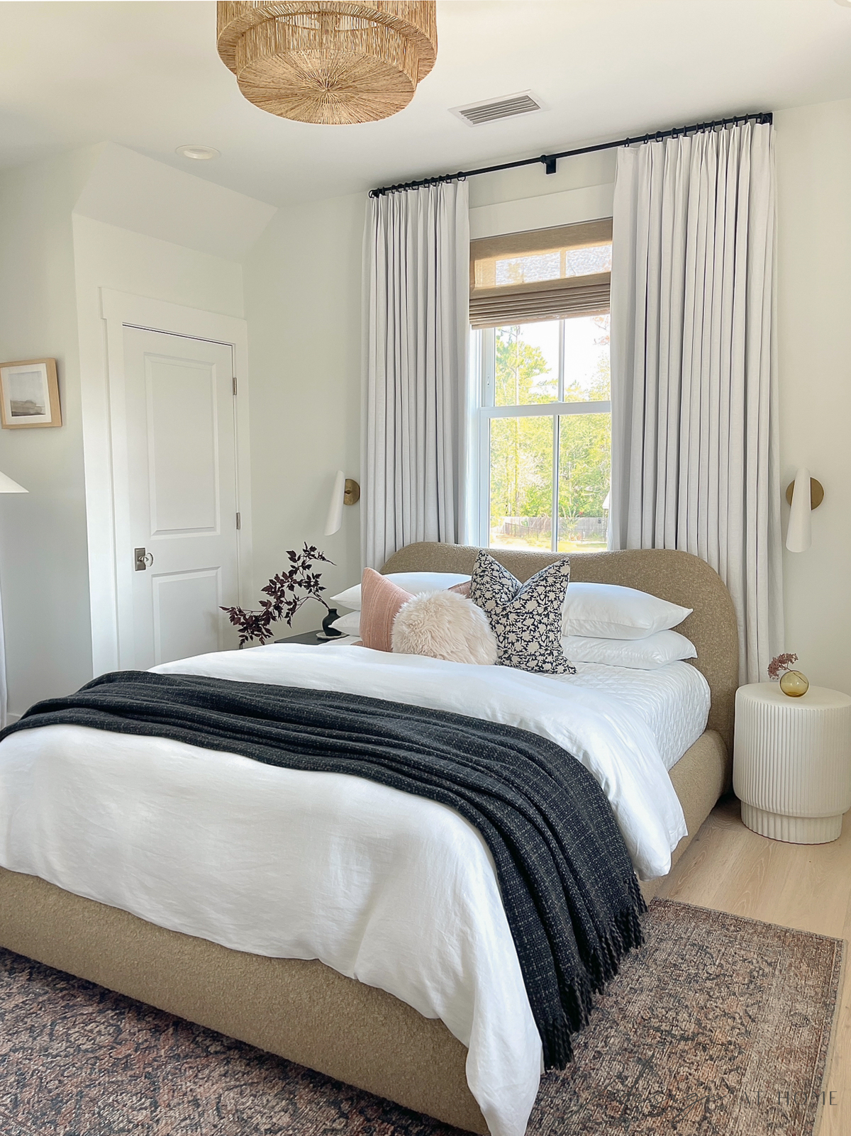 transitional modern guest room with neutral linens and oriental rug 