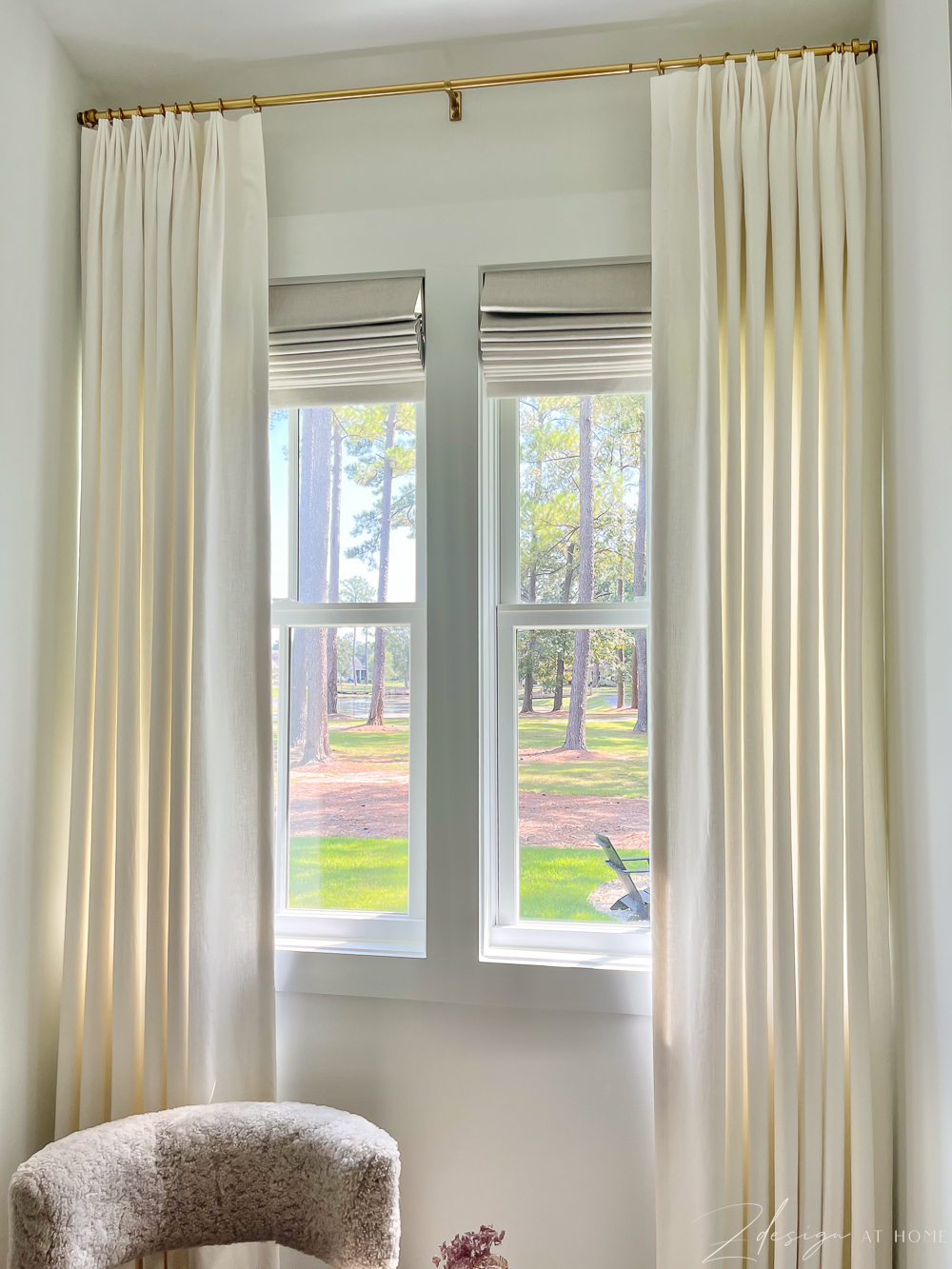 view of pond from master bath window with white linen pinch pleat curtains 