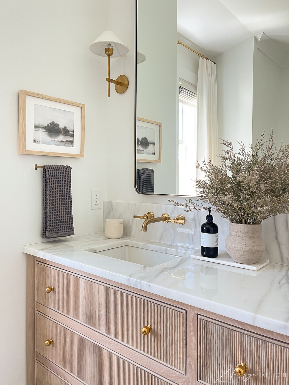 master bath with white oak fluted drawers, marble countertops and brass fixtures, transitional modern bathroom 