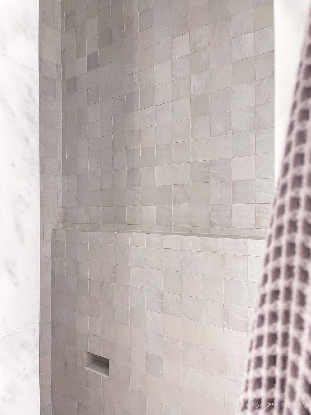 white zellige tile shower with ledge and foot niche 