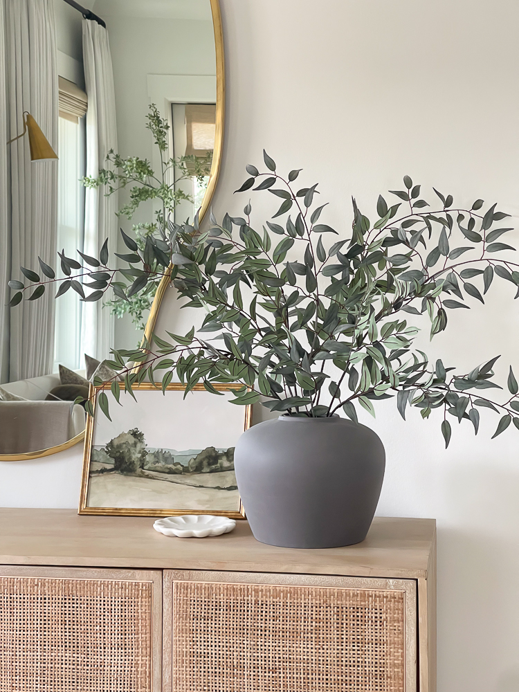 italian ruscus stems in matte gray vase styled in entryway 