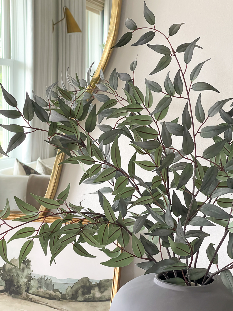 italian ruscus stems from afloral styled in entryway 