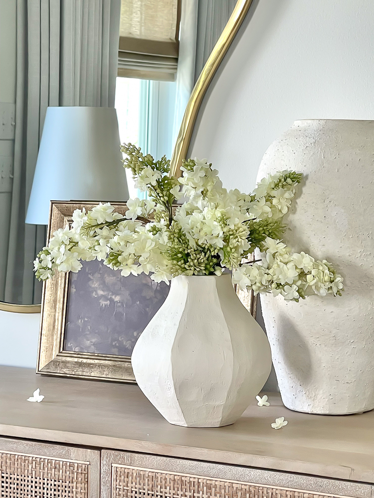 beautiful faux lilac florals in white crate & barrel vase 