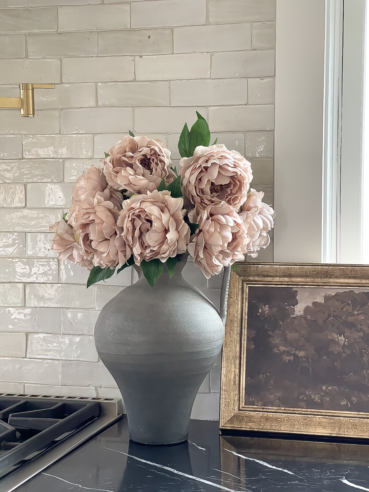 tissue paper peony from afloral in black jug vase in kitchen