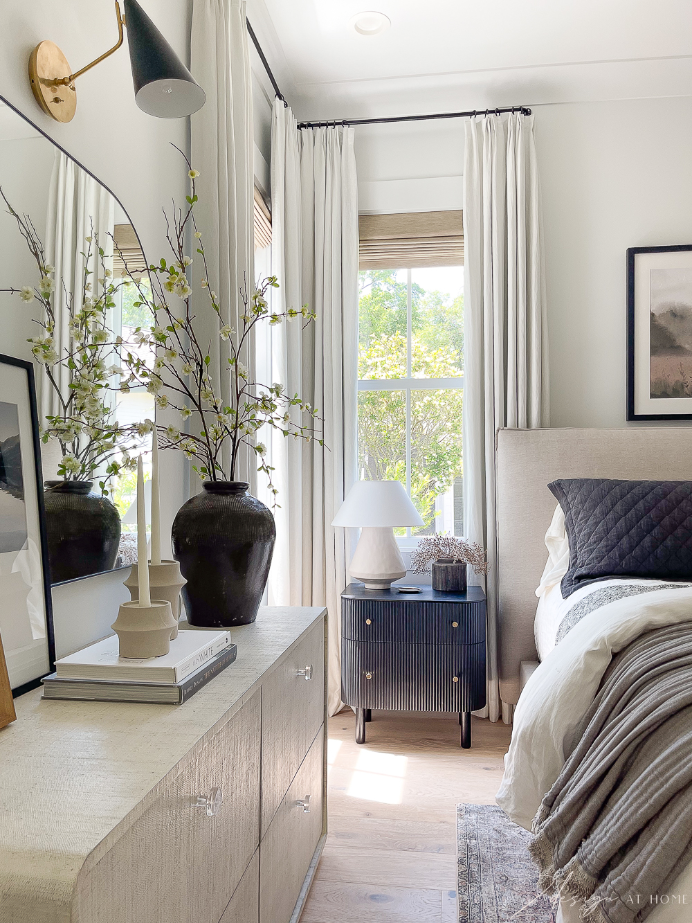 primary bedroom styled dresser and nightstand. white linen topages curtains 