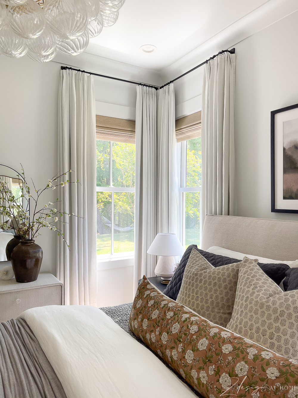 white curtains in the corner of a room two windows